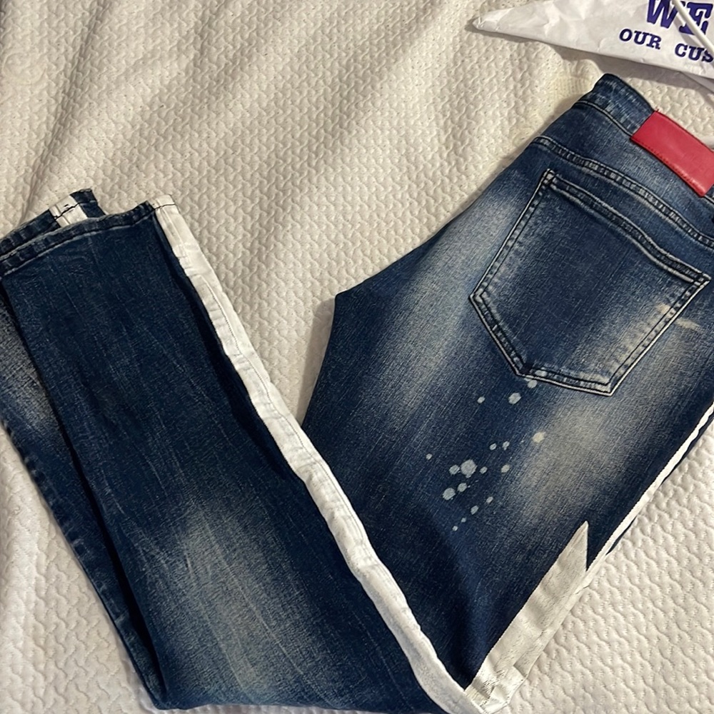 Dark blue jeans with white lightning stripe down legs